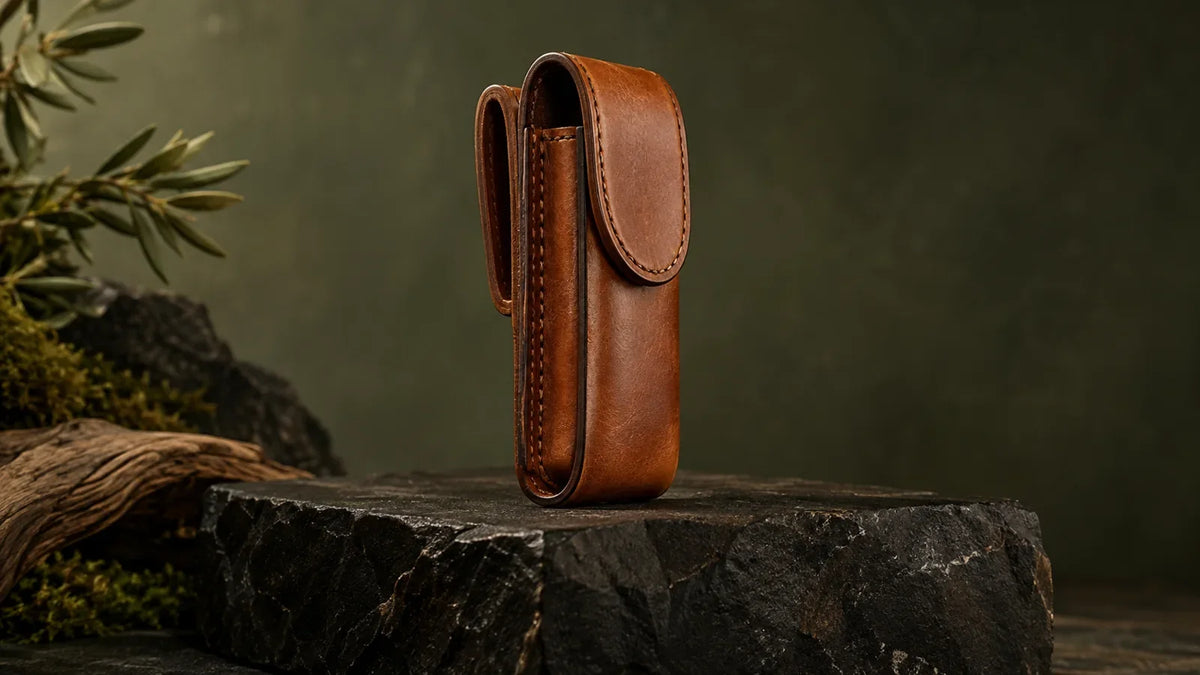Premium cognac leather closed folding-tool belt pouch standing upright on a block of black stone