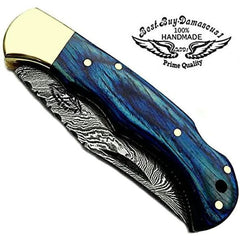 Handmade Damascus folding pocket knife closed, blue wood handle and brass bolster